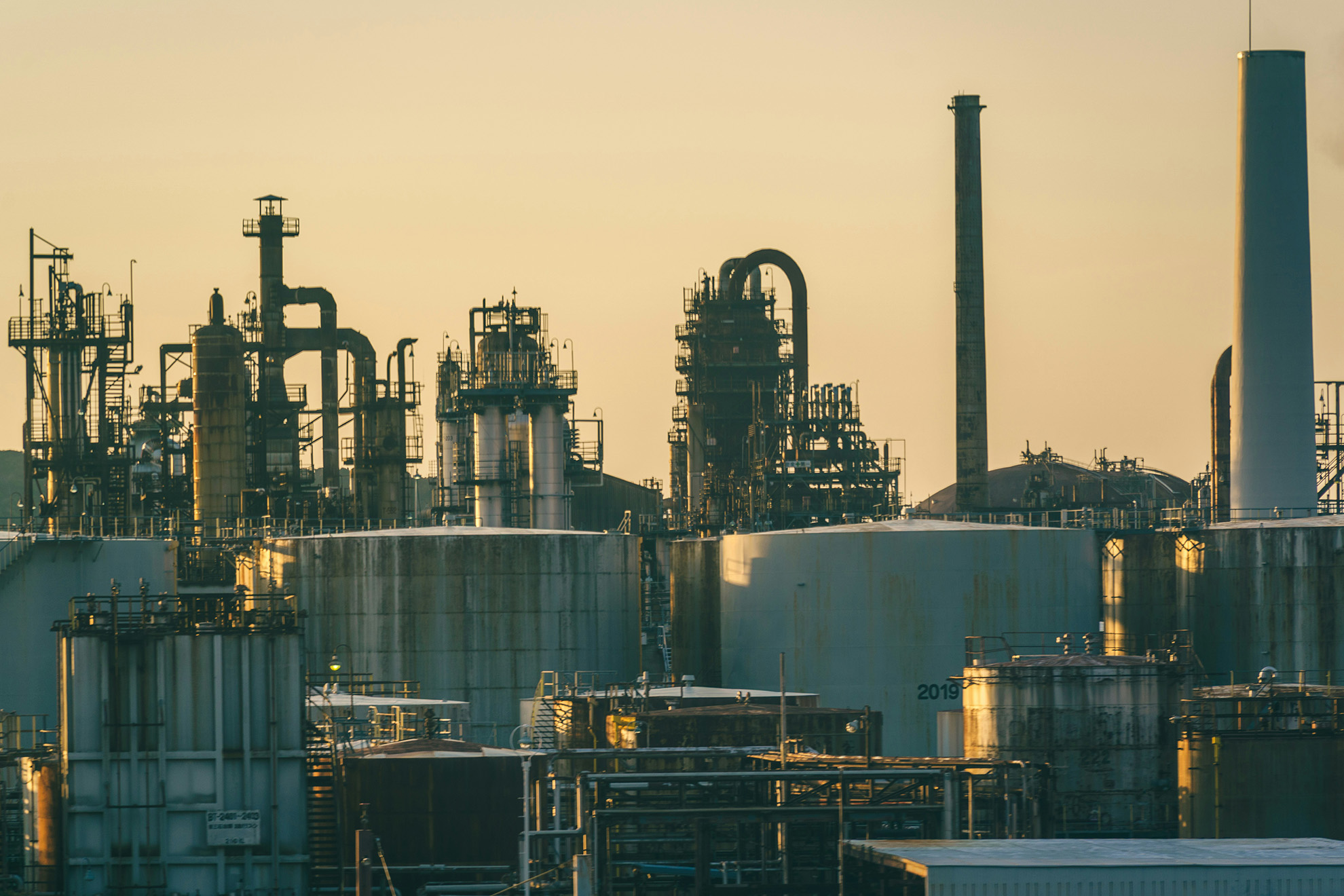 Refinery towers, processing equipment and storage tanks in warm evening light