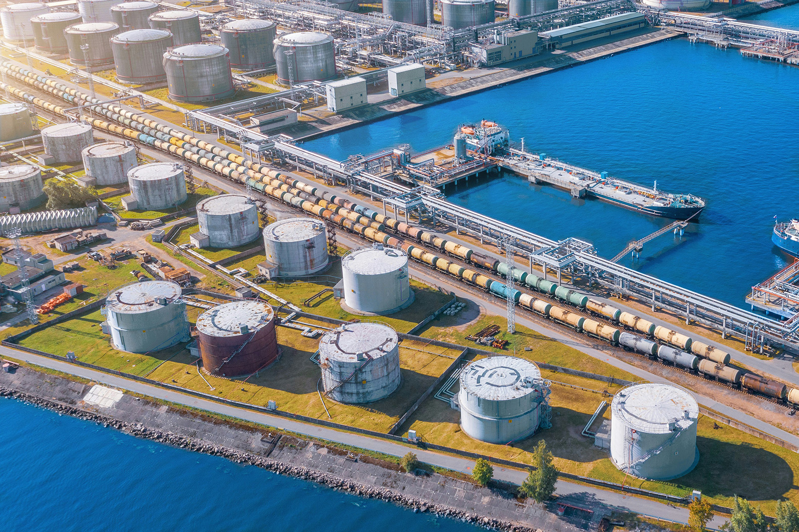 Waterfront storage tanks linked by pipelines to rail and marine berths